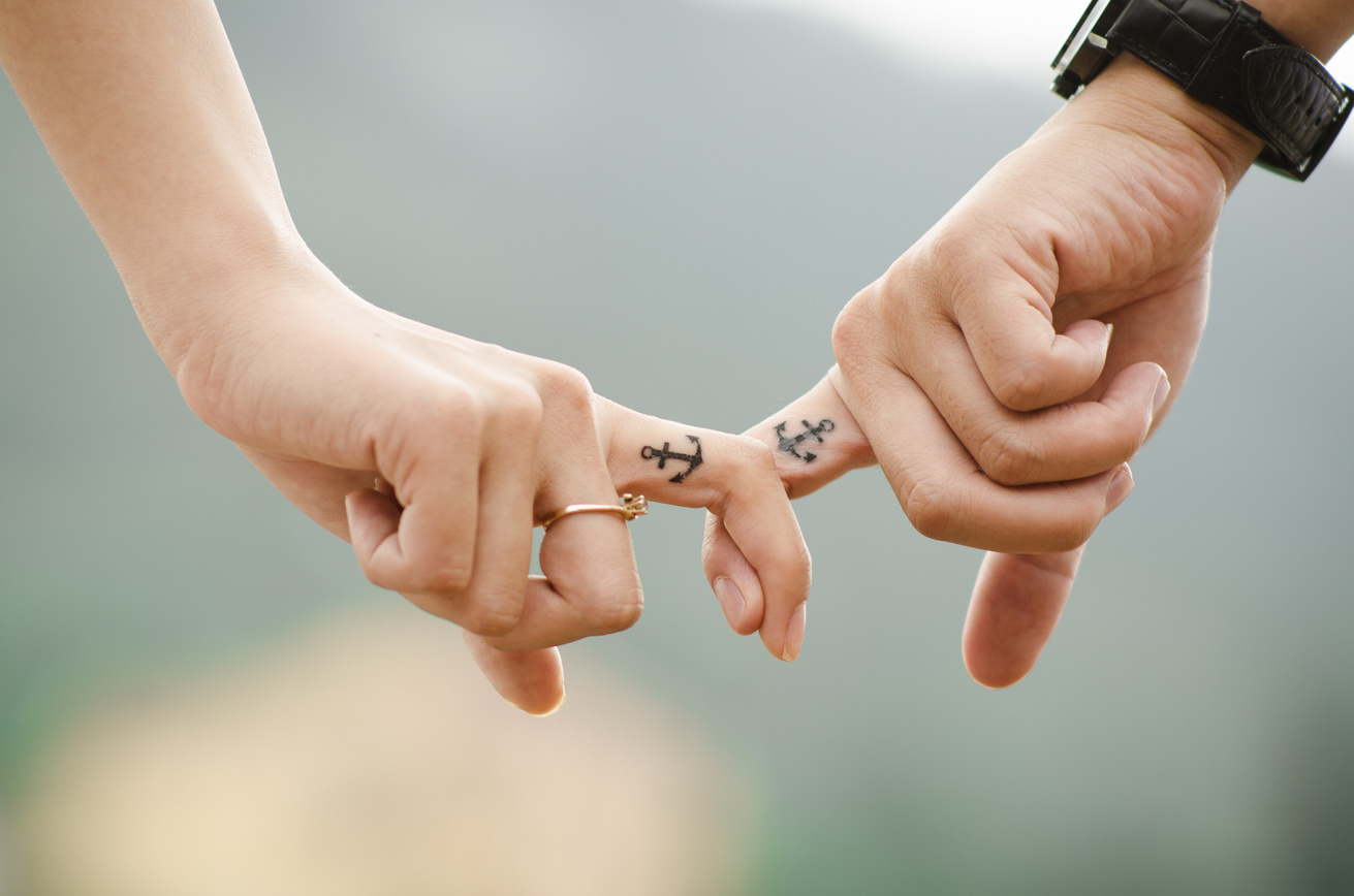 Couple with Anchor Tattoos on Fingers